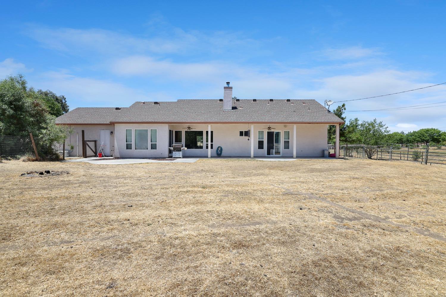 16787 Monreal Road Madera, CA 93636 - Photo 25 of 35 a front view of a house with a yard