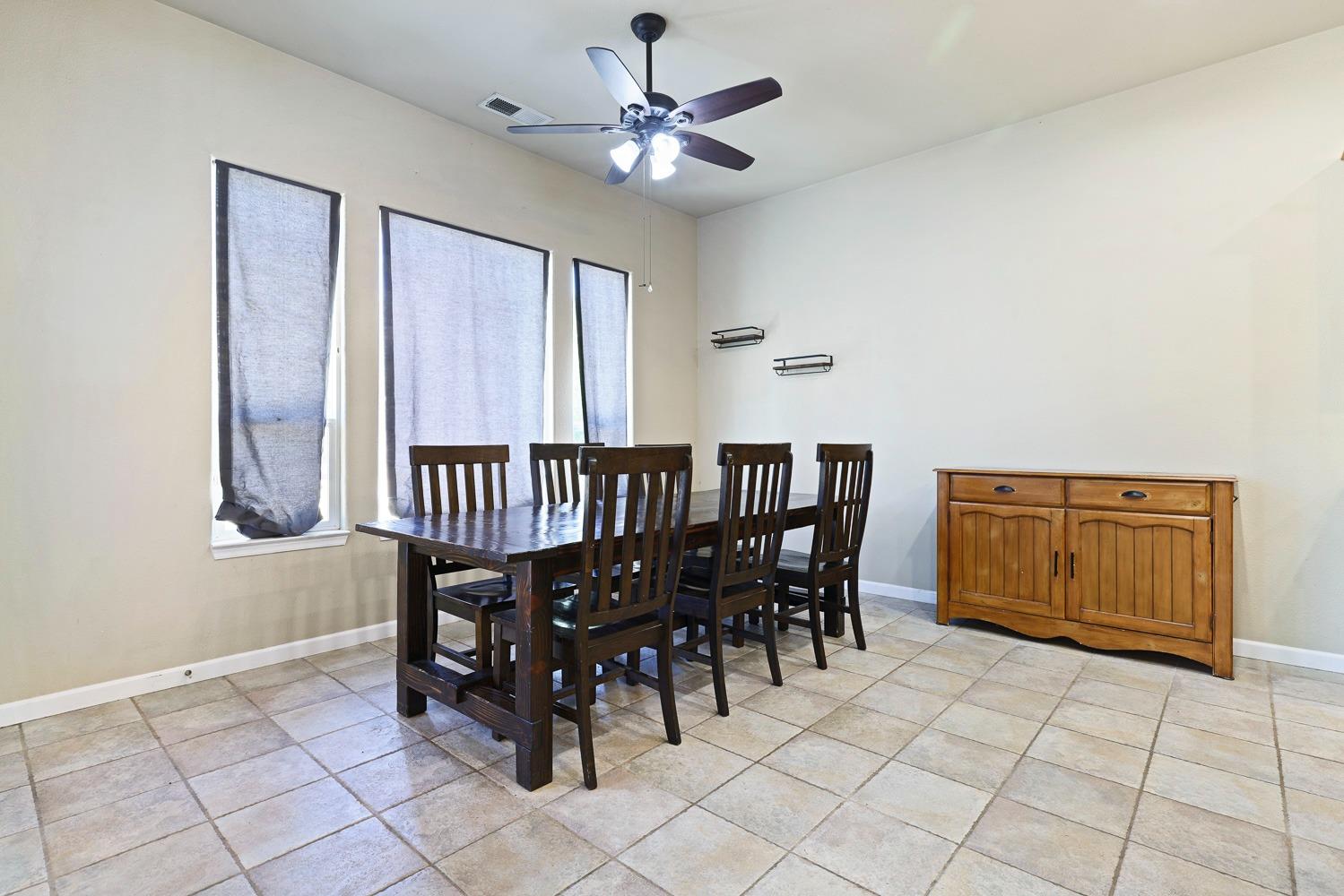 16787 Monreal Road Madera, CA 93636 - Photo 9 of 35 a dining room with furniture and chandelier