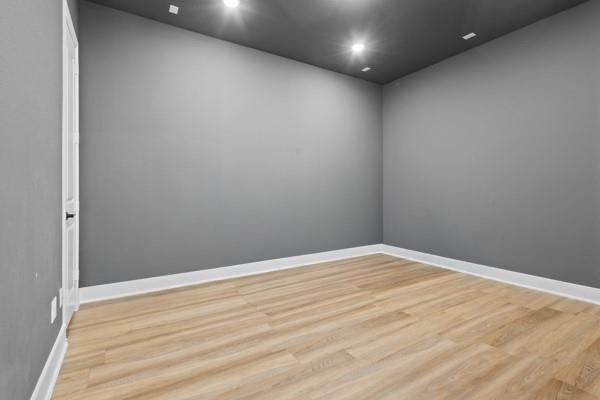 1825 Rough Rdg Trail Midlothian, TX 76065 - Photo 23 of 37 Room featuring contemporary gray walls, recessed lighting, and light wood-finish flooring