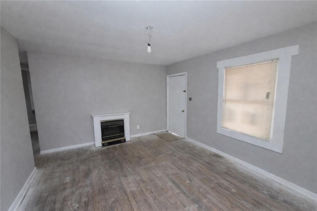 334 Argus Circle Northwest Atlanta, GA 30331 - Photo 2 of 14 an empty room with windows and fireplace