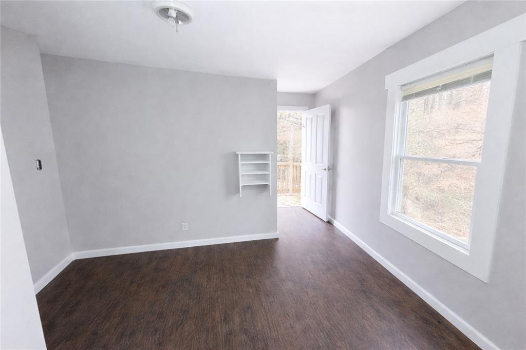 334 Argus Circle Northwest Atlanta, GA 30331 - Photo 6 of 14 an empty room with wooden floor and windows
