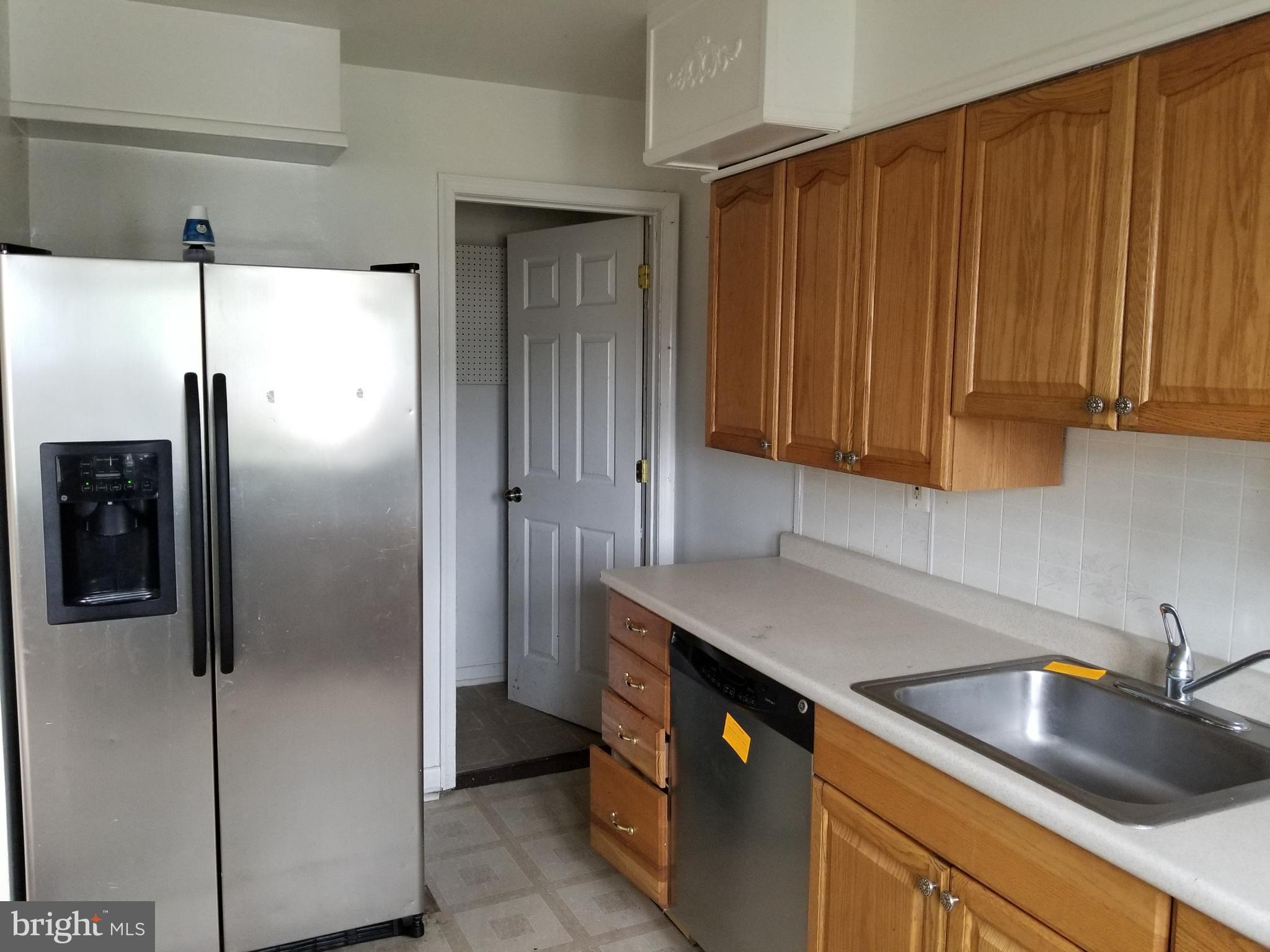 9750 Conmar Road Baltimore, MD 21220 - Photo 9 of 20 a kitchen with stainless steel appliances granite countertop a refrigerator and a sink