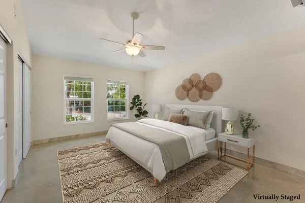 a bedroom with a large bed and a window