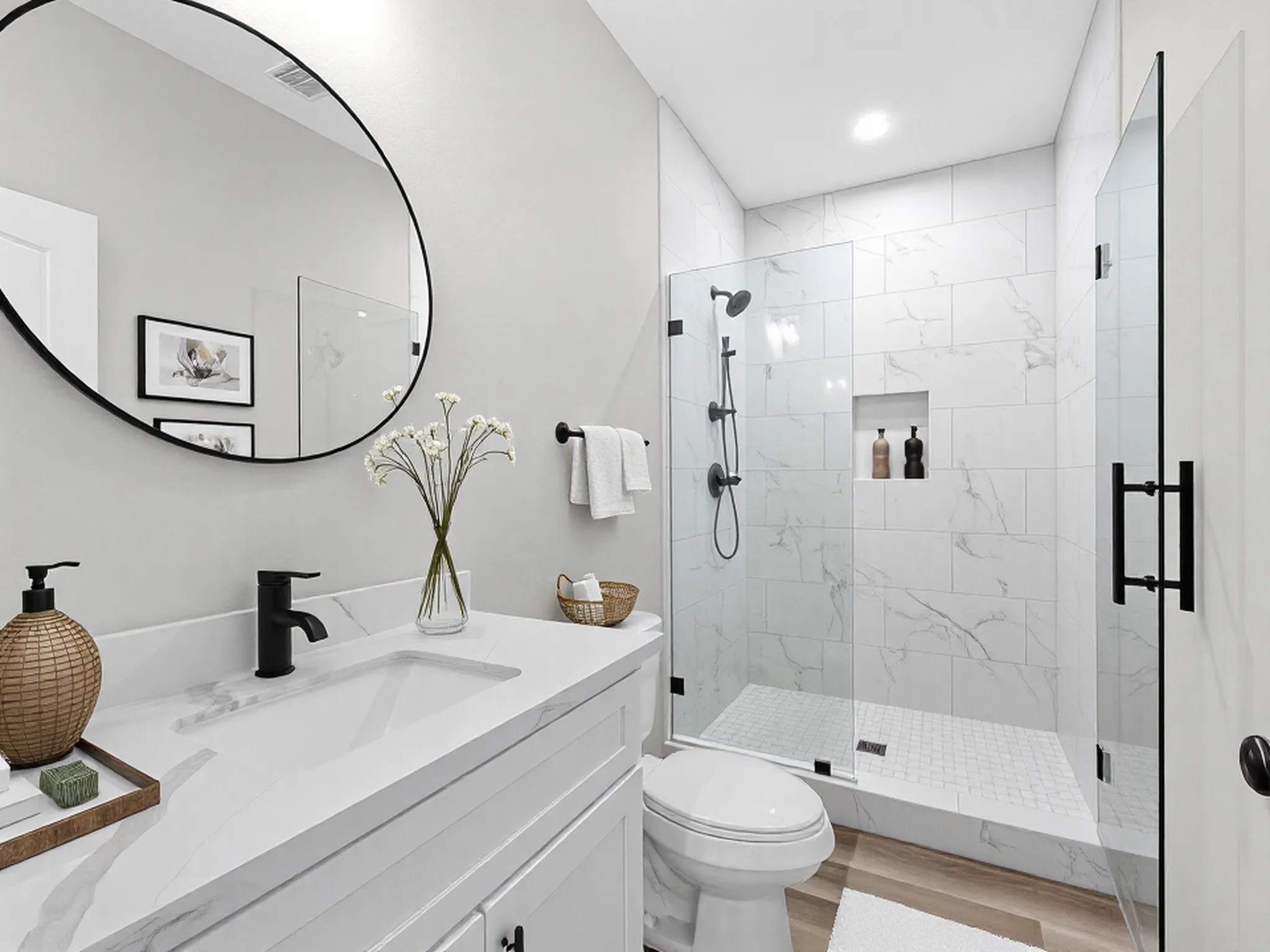 1319 West Bell Street Houston, TX 77019 - Photo 17 of 50 *Note* This photo is virtually staged*
This bathroom features a modern design with a large round mirror above a sleek vanity. It includes a spacious glass-enclosed shower with elegant tile work, a mounted showerhead, and built-in shelving. The room is bright and airy, accented with tasteful decor awaits.