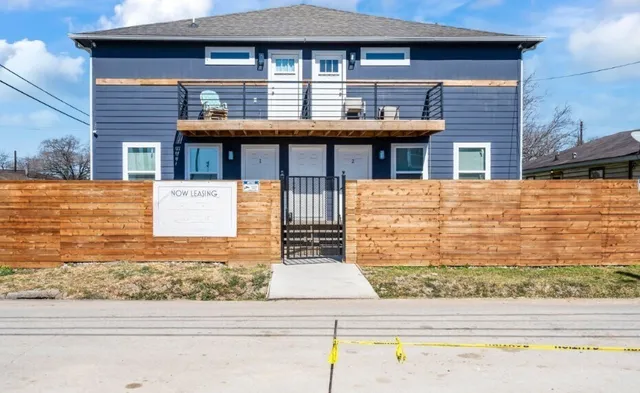 a front view of a house with garage and parking