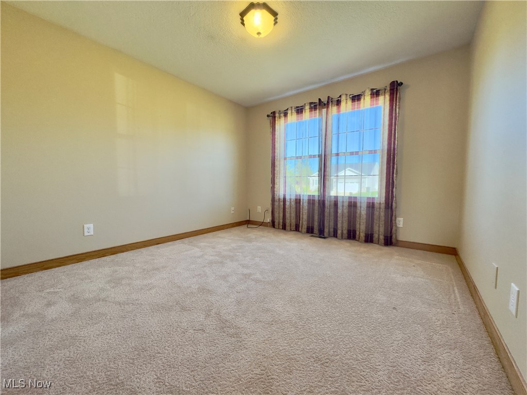 6014 Wentworth Road Southwest Canton, OH 44706 - Photo 15 of 22 Bedroom featuring light carpet and a textured ceiling