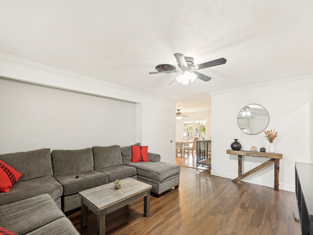 124 Bluebird Lane Pasadena, TX 77502 - Photo 16 of 25 a living room with furniture a wooden floor and a ceiling fan