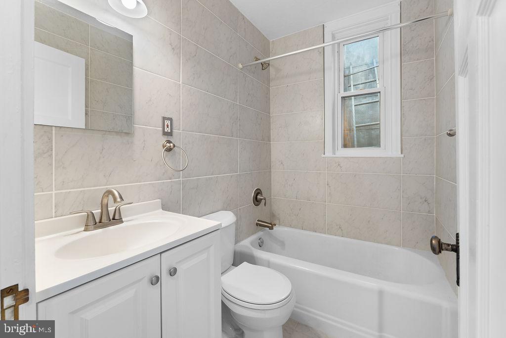 339 Drew Street Baltimore, MD 21224 - Photo 12 of 26 a bathroom with a sink toilet and shower