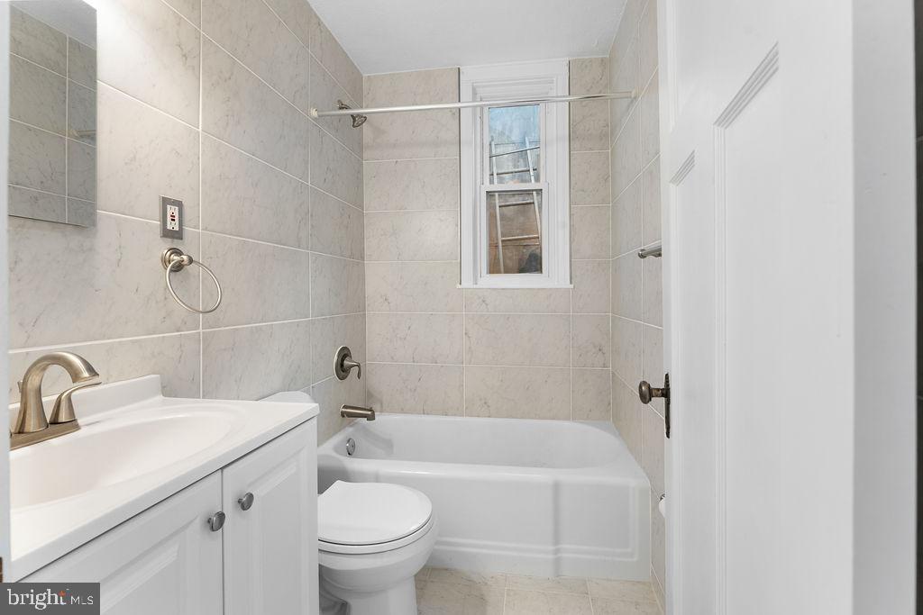 339 Drew Street Baltimore, MD 21224 - Photo 13 of 26 a bathroom with a sink toilet and shower