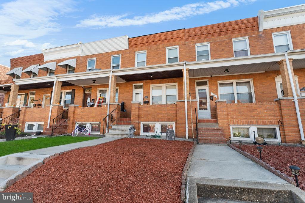 339 Drew Street Baltimore, MD 21224 - Photo 2 of 26 a front view of a house with a yard