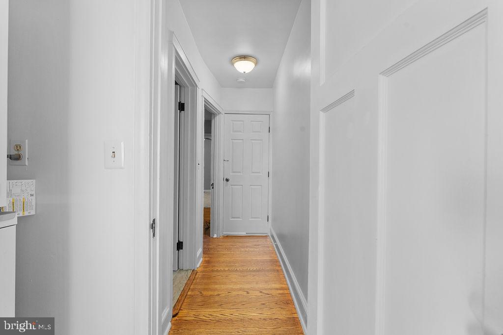 339 Drew Street Baltimore, MD 21224 - Photo 24 of 26 a view of a hallway with wooden floor and a bathroom