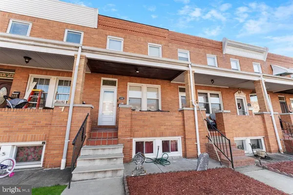 a front view of a residential apartment building with a yard