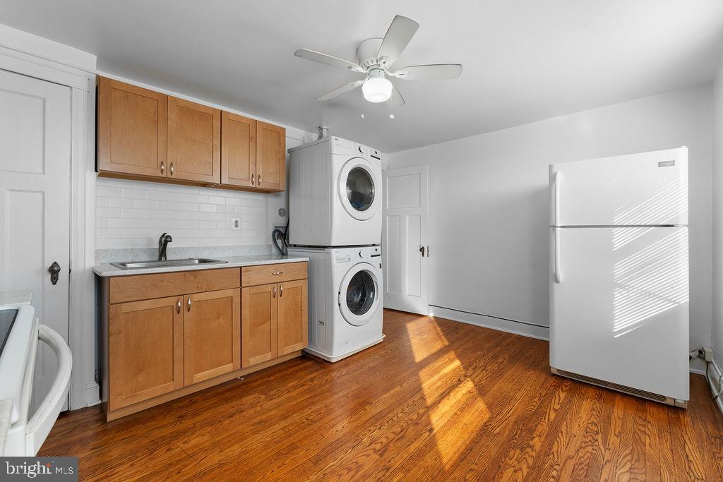 339 Drew Street Baltimore, MD 21224 - Photo 8 of 26 a kitchen with wooden cabinets and white appliances
