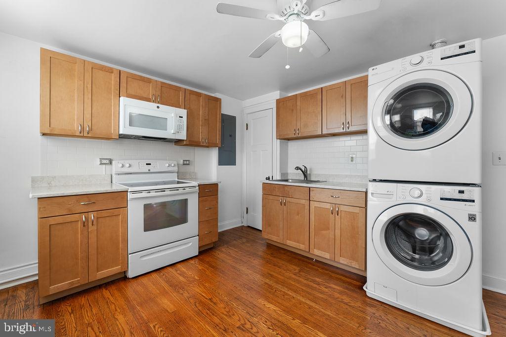 339 Drew Street Baltimore, MD 21224 - Photo 9 of 26 a kitchen with stainless steel appliances granite countertop a sink a stove a microwave and cabinets