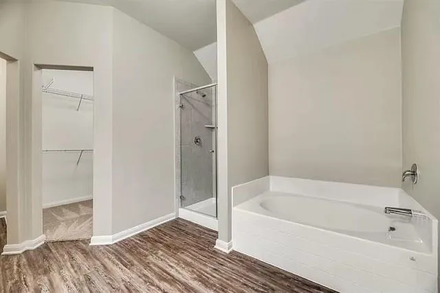 a white bath tub sitting next to a shower