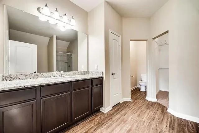 a bathroom with a double vanity sink and a mirror