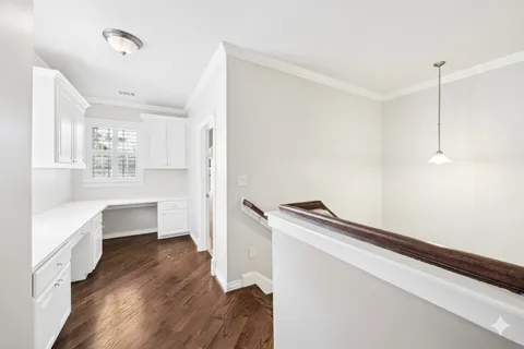 a kitchen with a stove and a wooden floor