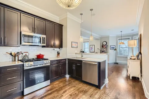 a kitchen with stainless steel appliances granite countertop a refrigerator sink and cabinets