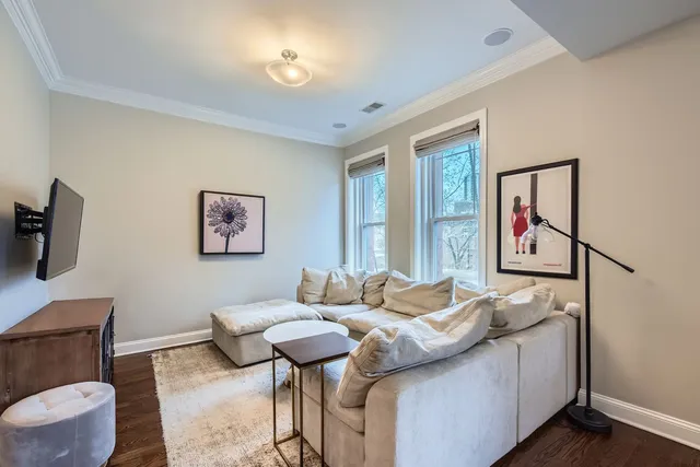 a view of a a dining room with furniture window and wooden floor