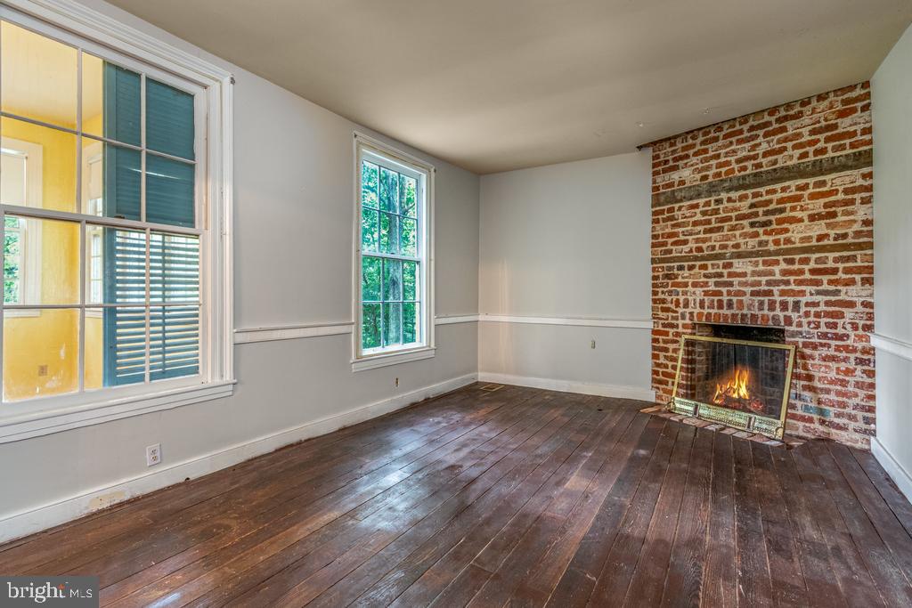 807 Holly Corner Road Fredericksburg, VA 22406 - Photo 13 of 57 a view of an empty room with wooden floor and a window