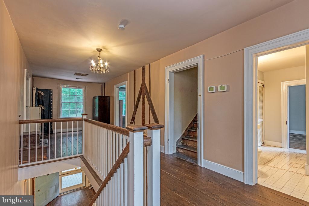 807 Holly Corner Road Fredericksburg, VA 22406 - Photo 21 of 57 a view of a hallway with wooden floor and stairs