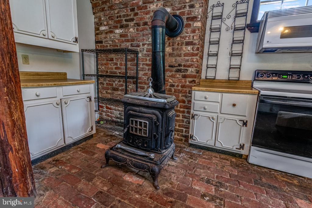 807 Holly Corner Road Fredericksburg, VA 22406 - Photo 32 of 57 a kitchen with cabinets and a stove