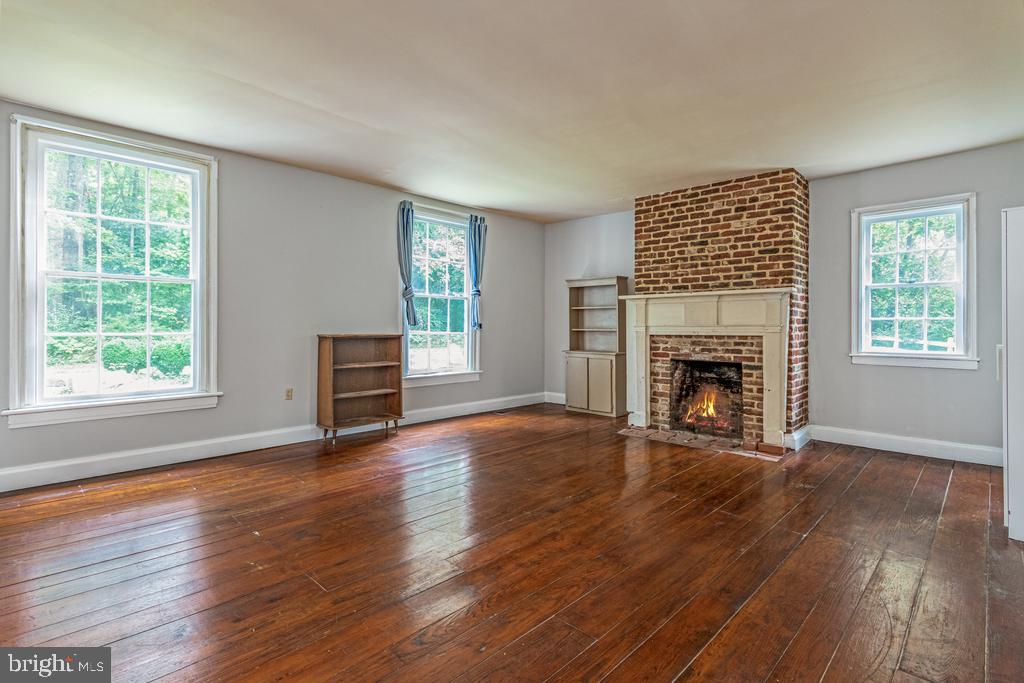 807 Holly Corner Road Fredericksburg, VA 22406 - Photo 8 of 57 a view of empty room with wooden floor and fireplace