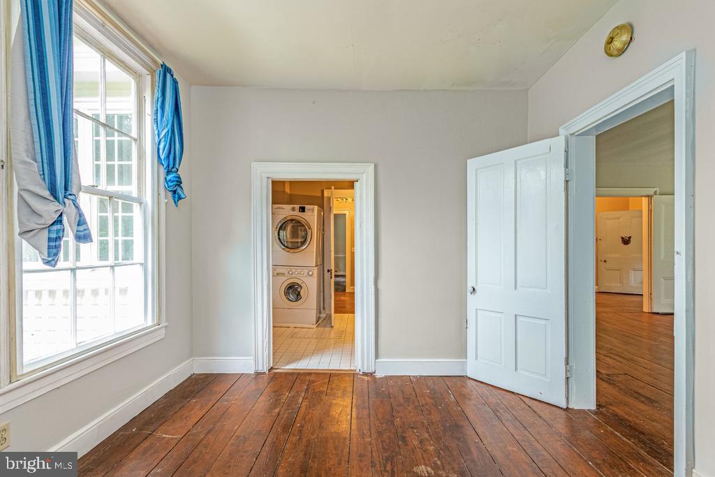 807 Holly Corner Road Fredericksburg, VA 22406 - Photo 9 of 57 a view of empty room with wooden floor and fan