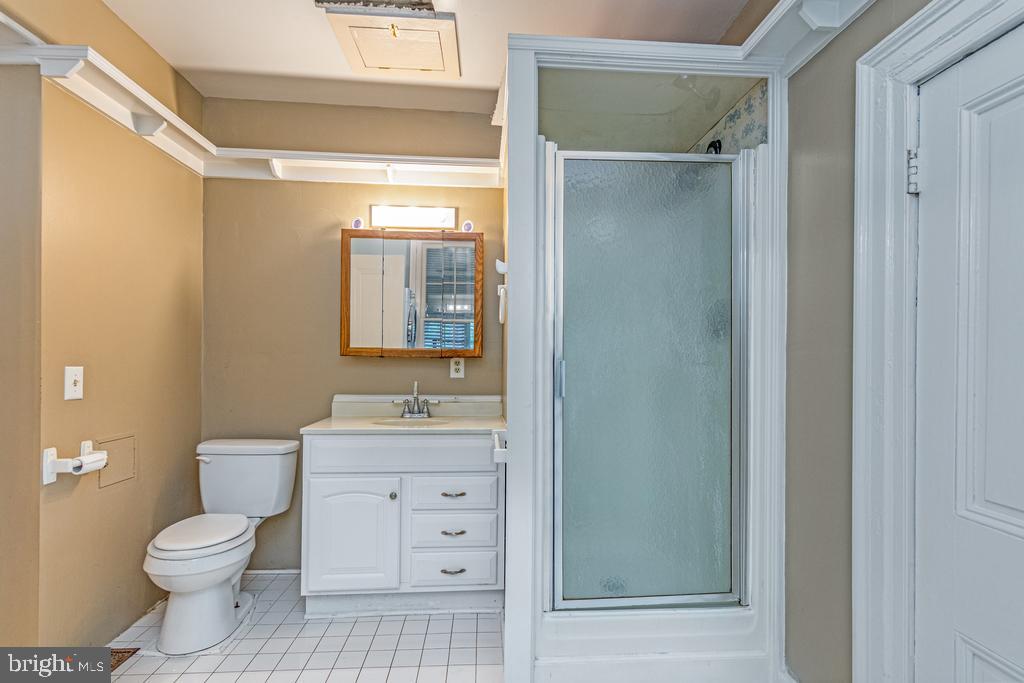 807 Holly Corner Road Fredericksburg, VA 22406 - Photo 10 of 57 a bathroom with a toilet a sink and a mirror