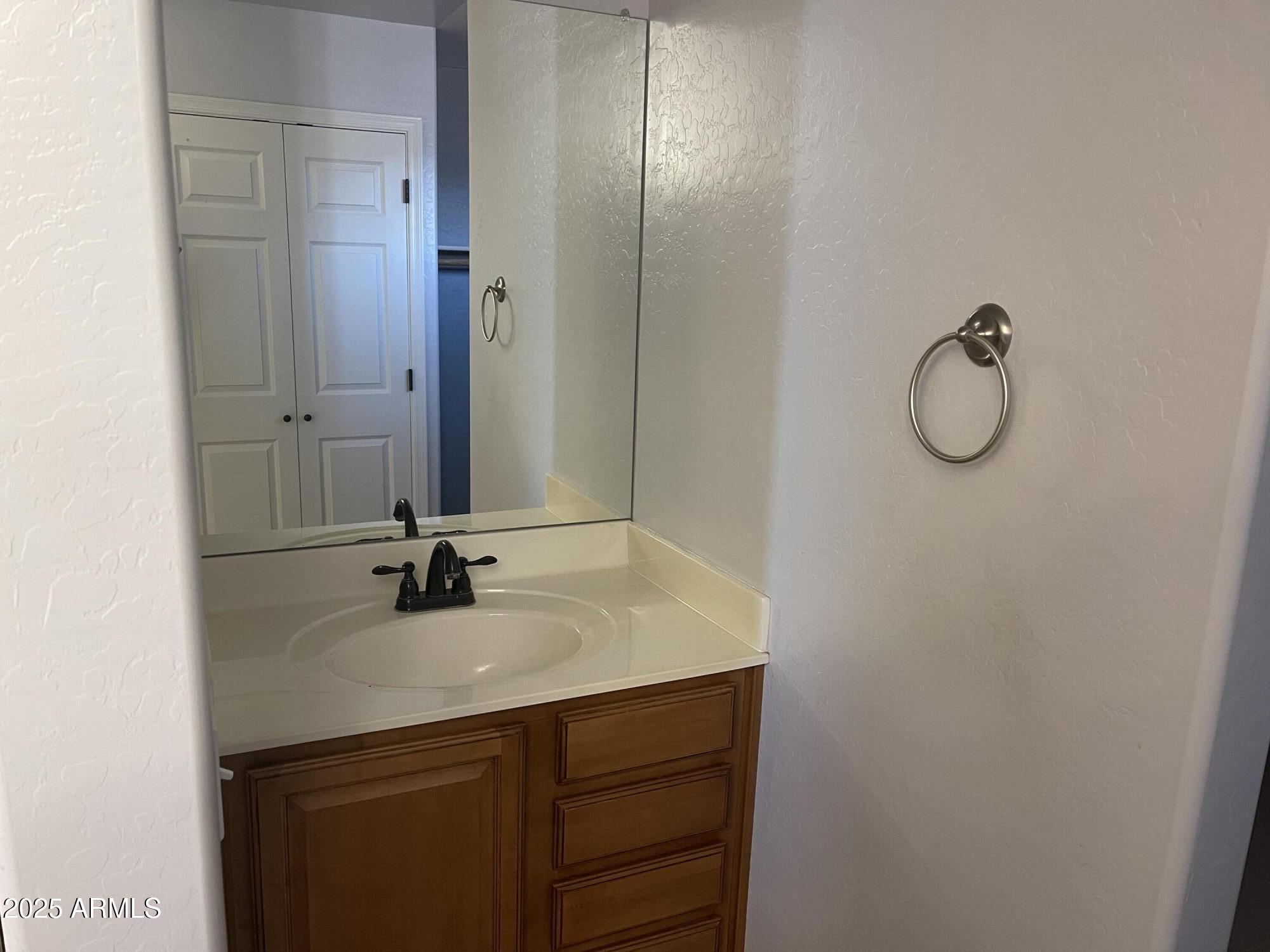 51355 West Century Road Maricopa, AZ 85139 - Photo 15 of 33 a bathroom with a sink and mirror