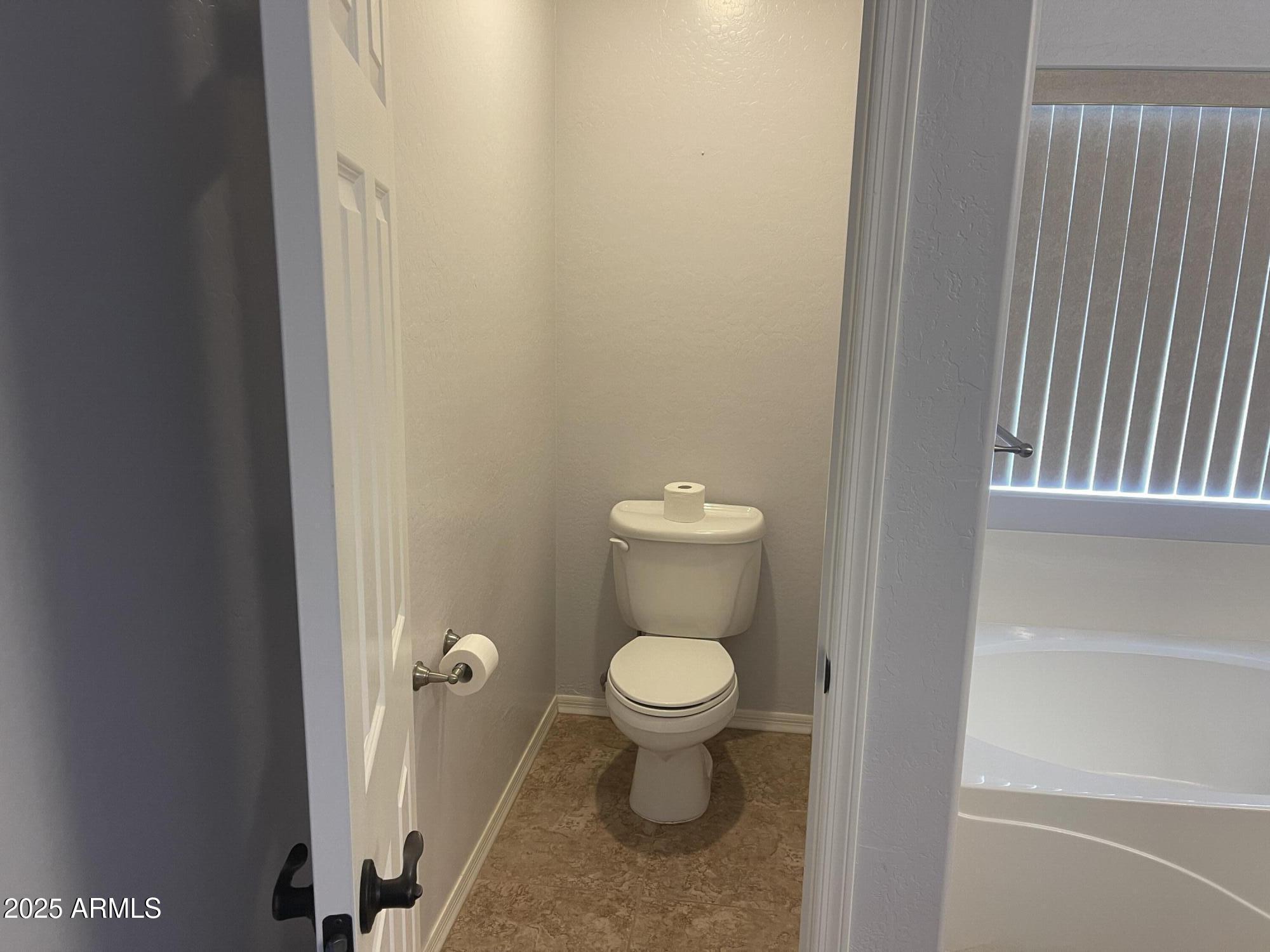51355 West Century Road Maricopa, AZ 85139 - Photo 16 of 33 a bathroom with a toilet and a sink