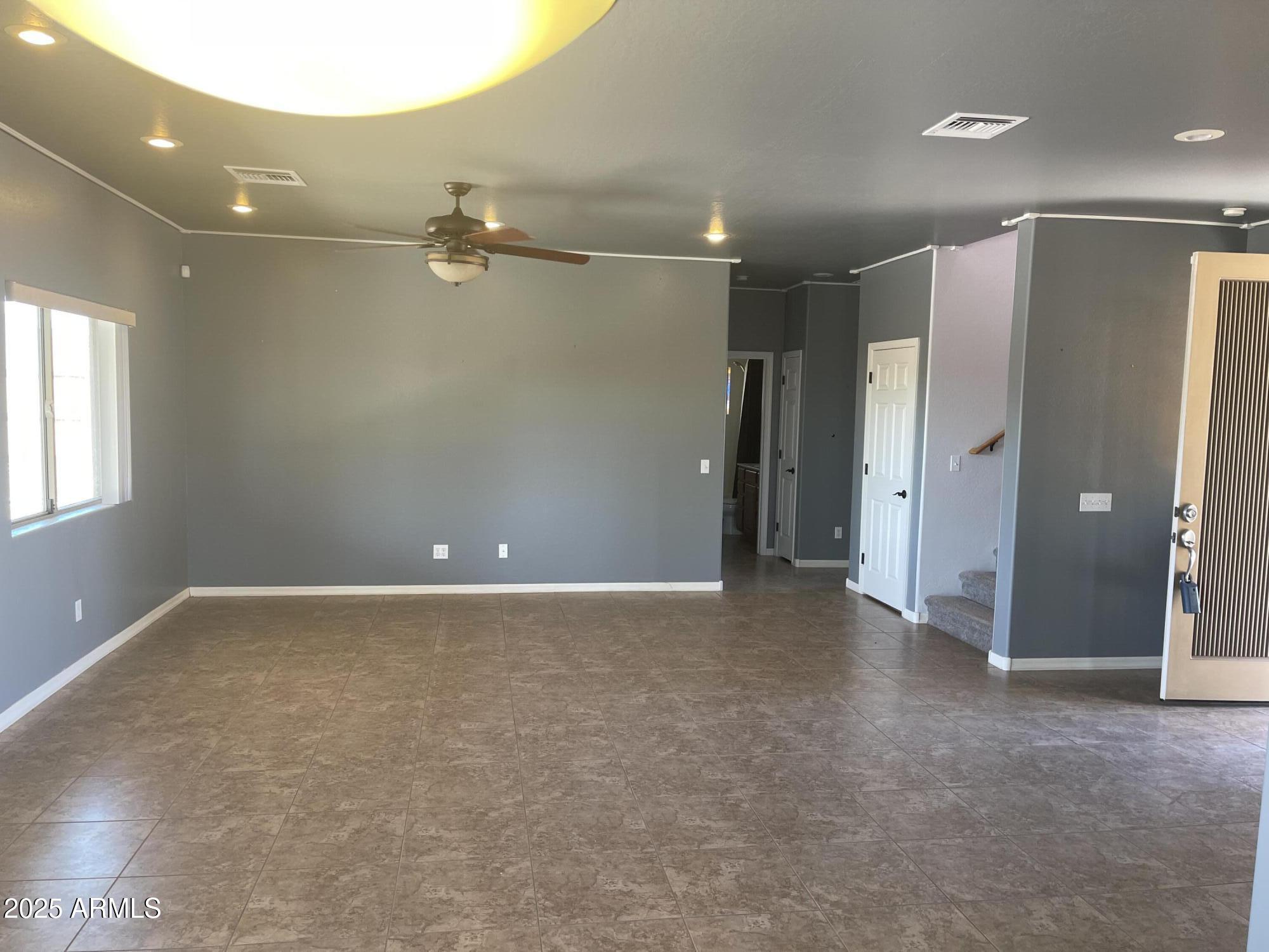 51355 West Century Road Maricopa, AZ 85139 - Photo 2 of 33 an empty room with closet and windows