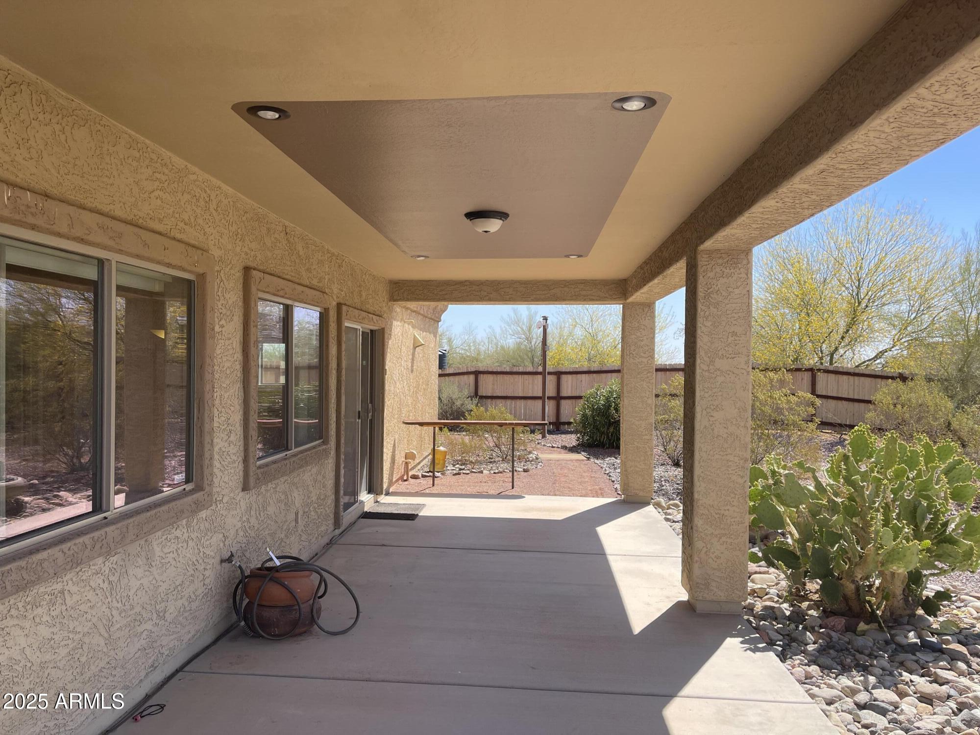 51355 West Century Road Maricopa, AZ 85139 - Photo 22 of 33 a building outdoor space with patio furniture and potted plants