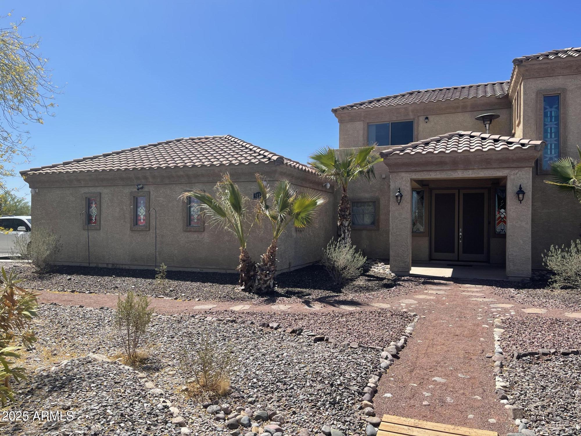 51355 West Century Road Maricopa, AZ 85139 - Photo 25 of 33 a front view of a house with a yard