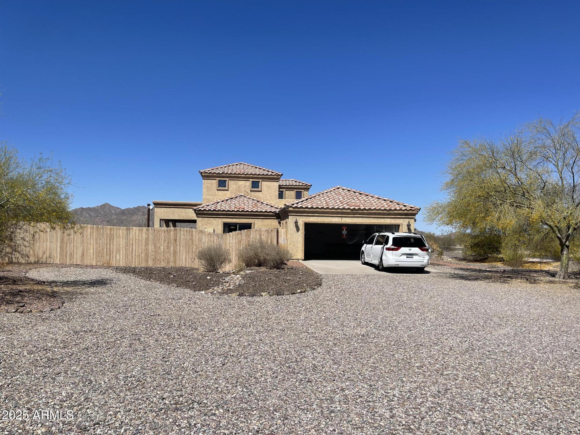 51355 West Century Road Maricopa, AZ 85139 - Photo 28 of 33 a front view of a house with a yard