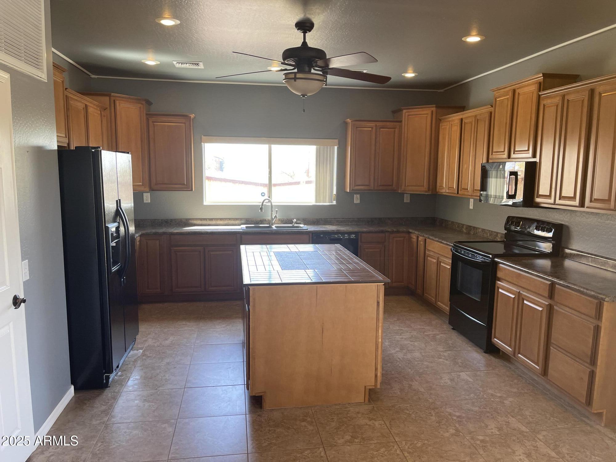 51355 West Century Road Maricopa, AZ 85139 - Photo 3 of 33 a kitchen with stainless steel appliances granite countertop a sink stove and refrigerator