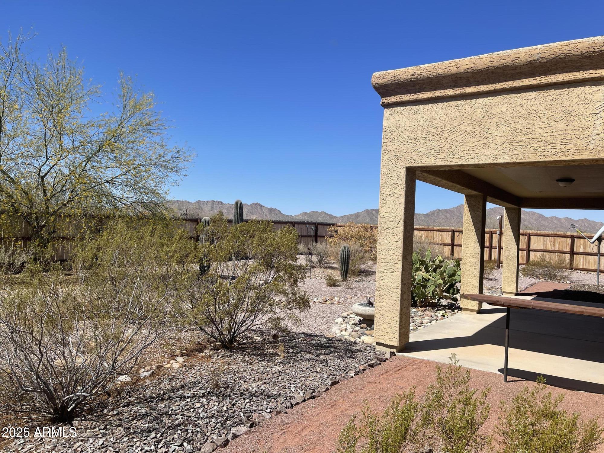 51355 West Century Road Maricopa, AZ 85139 - Photo 4 of 33 a view of balcony with couch and wooden floor