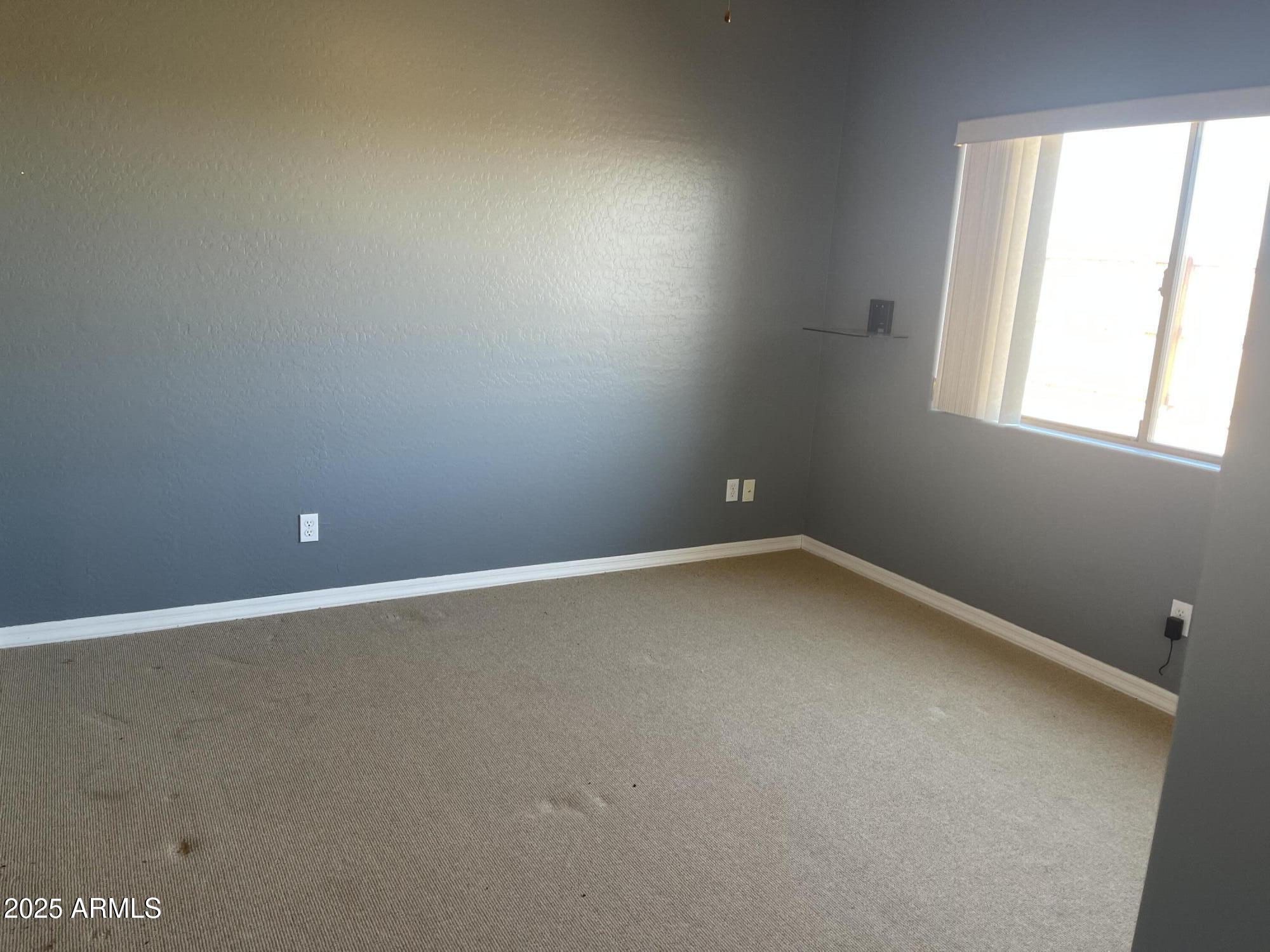 51355 West Century Road Maricopa, AZ 85139 - Photo 10 of 33 an empty room with a window