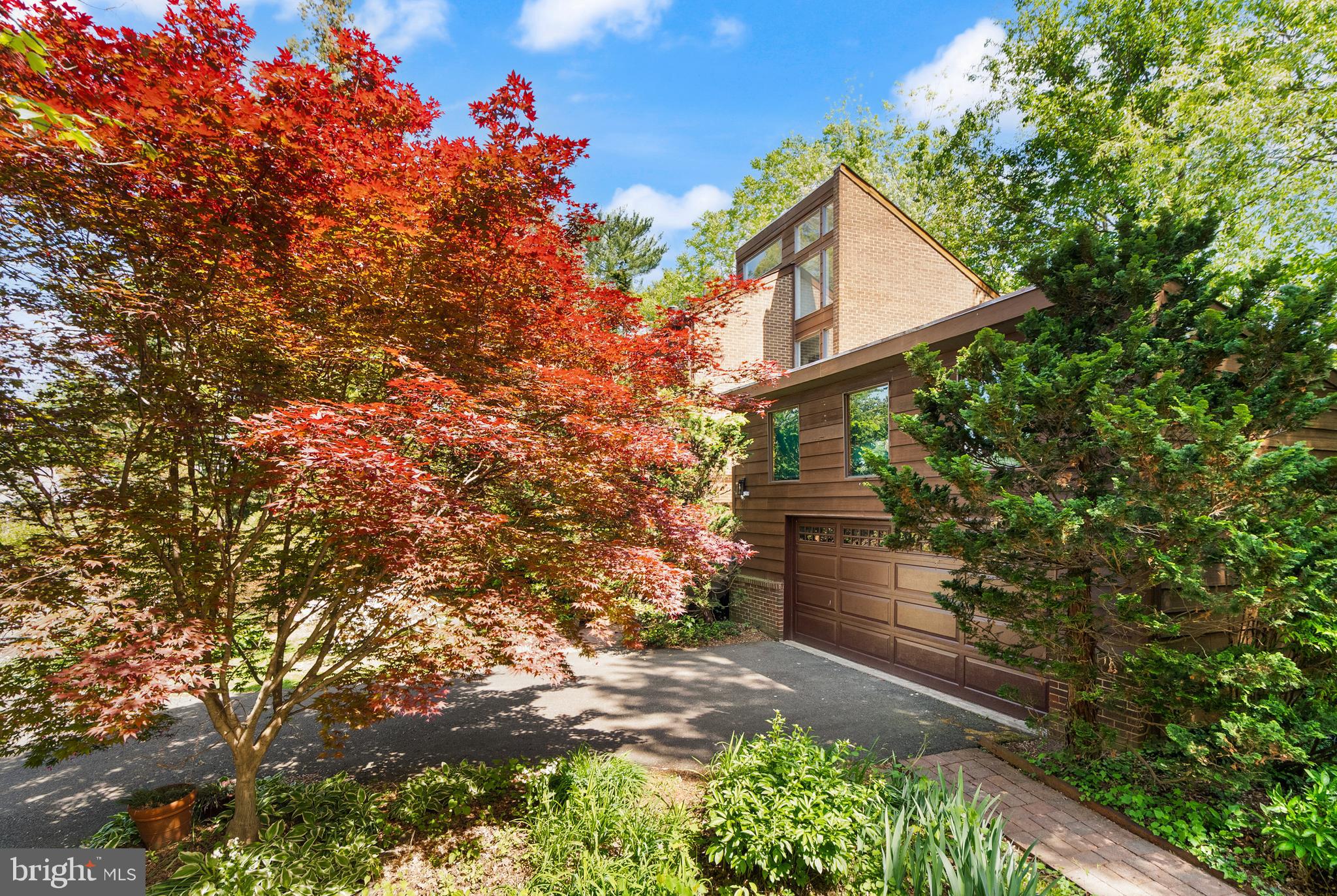 Chain Bridge McLean, VA 22101 - Photo 44 of 60 a front view of a house with a yard and tree s