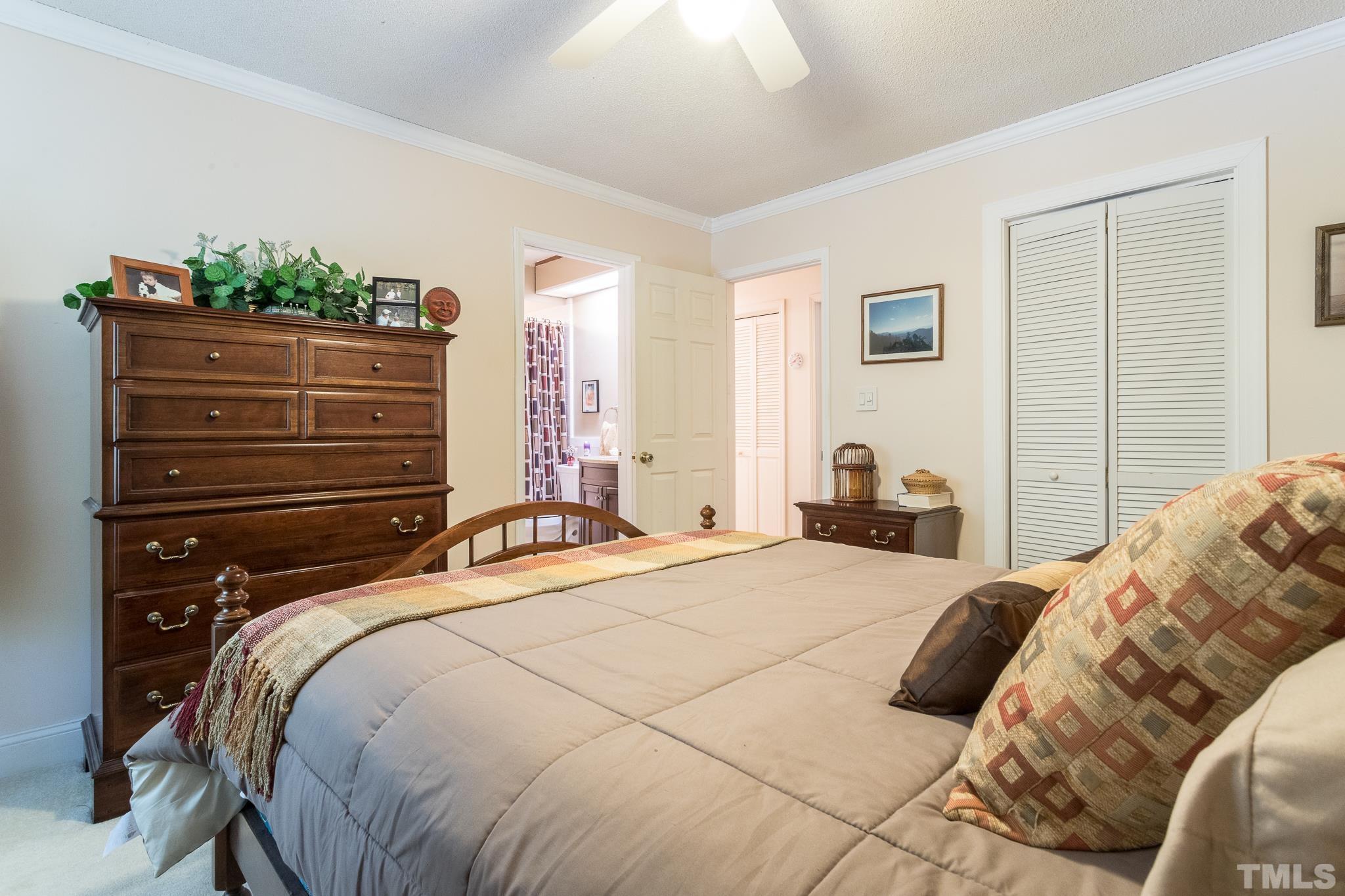 9 Pinnacle Road Durham, NC 27705 - Photo 17 of 25 a bedroom with a bed and a flat tv screen