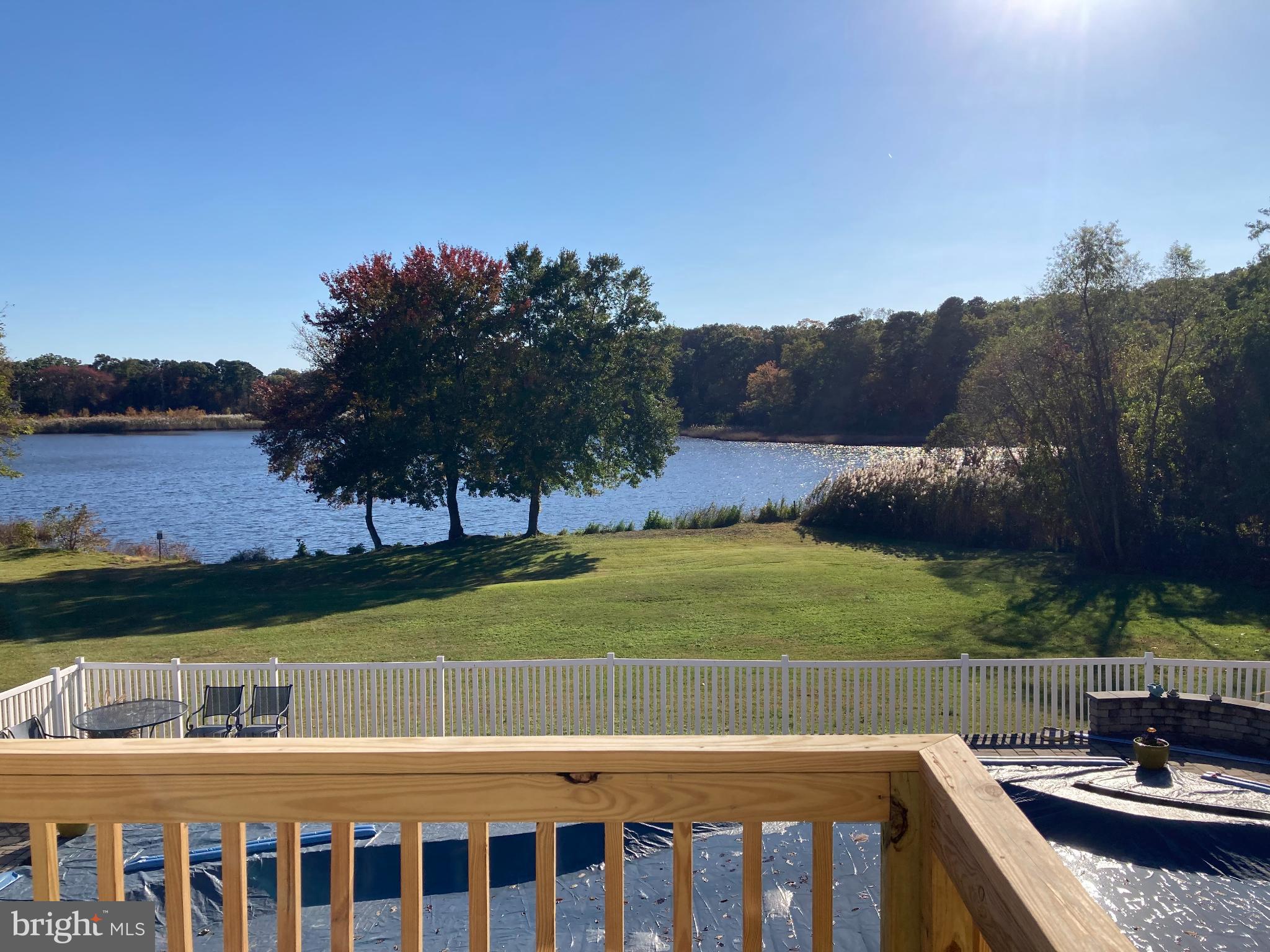 1419 Pond Ridge Drive Pasadena, MD 21122 - Photo 33 of 49 Serene lakeside view with vibrant foliage.