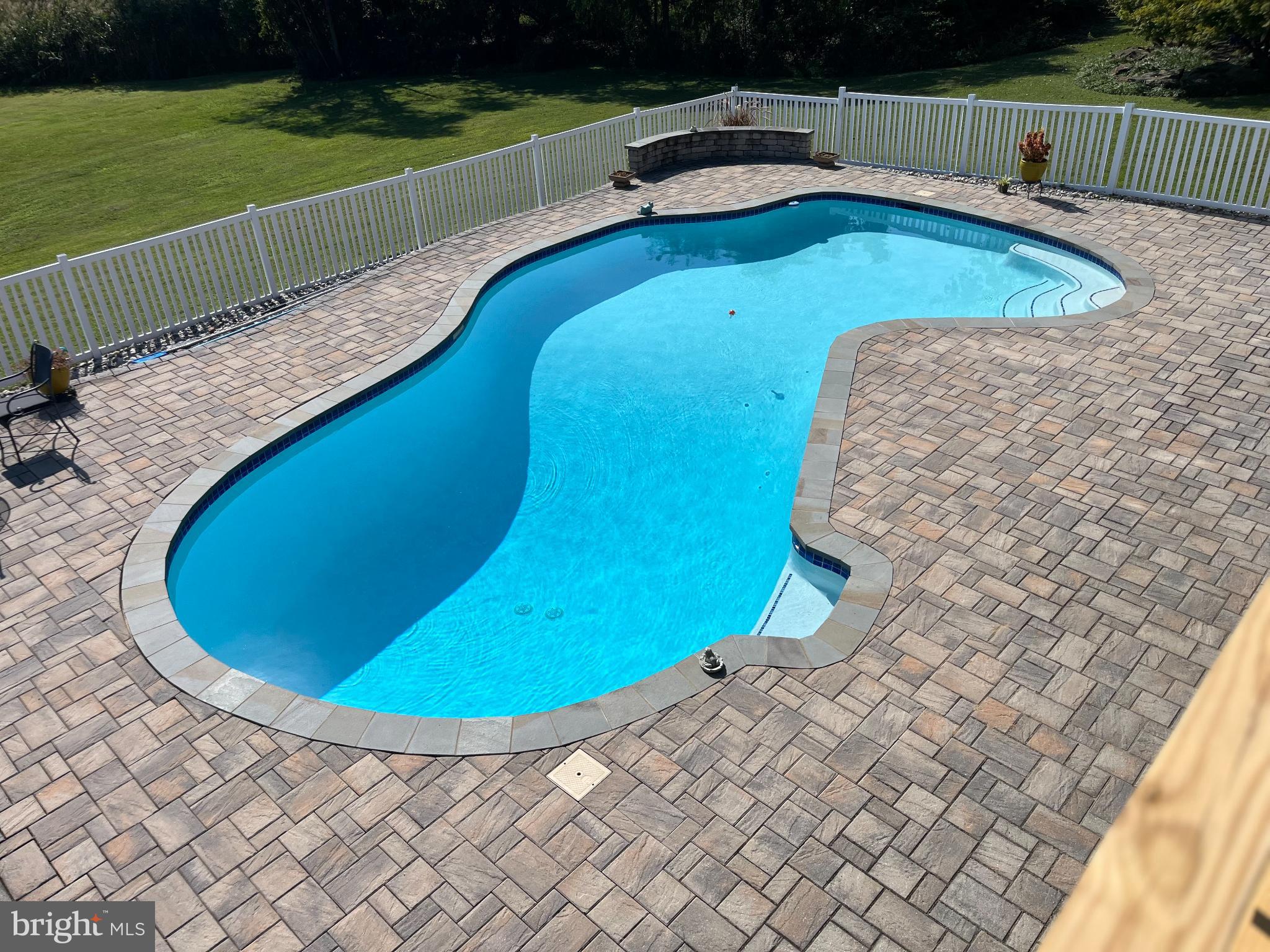 1419 Pond Ridge Drive Pasadena, MD 21122 - Photo 35 of 49 Serene poolside retreat in lush surroundings.