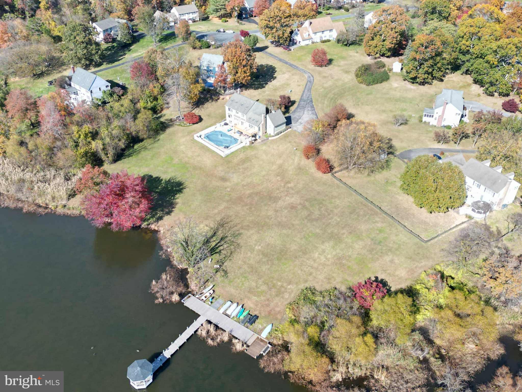 1419 Pond Ridge Drive Pasadena, MD 21122 - Photo 44 of 49 Serene lakeside homes in vibrant autumn hues.