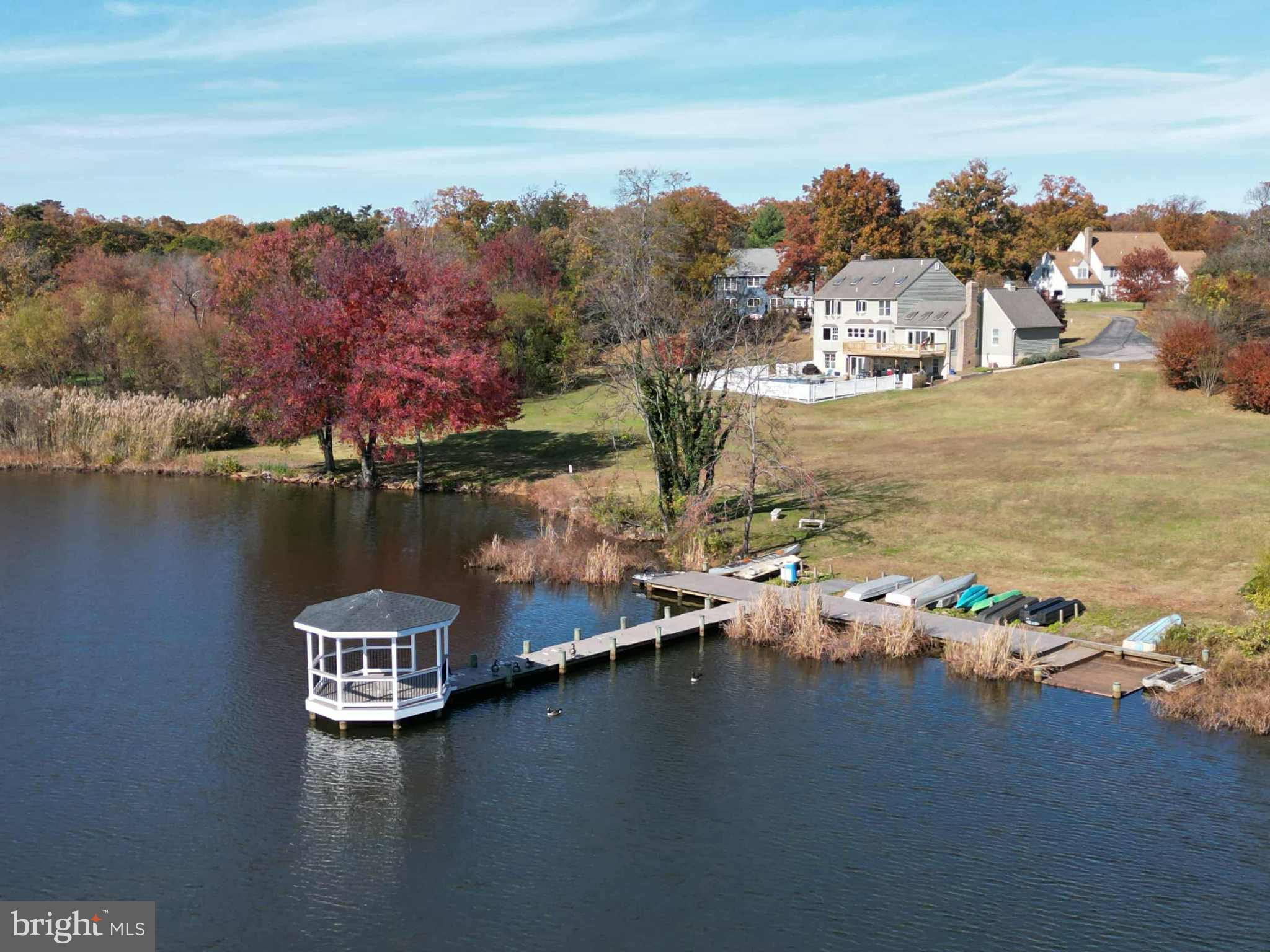 1419 Pond Ridge Drive Pasadena, MD 21122 - Photo 45 of 49 Serene lakeside retreat with vibrant foliage.