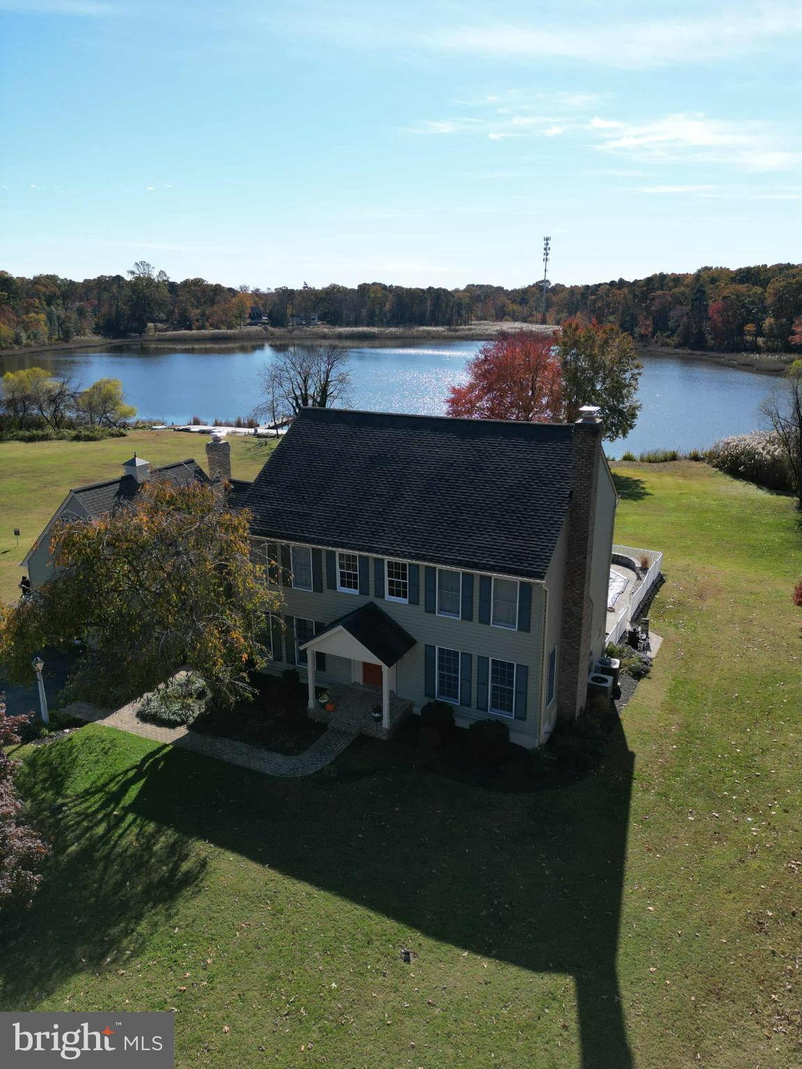 1419 Pond Ridge Drive Pasadena, MD 21122 - Photo 48 of 49 Serene lakeside home with vibrant foliage.