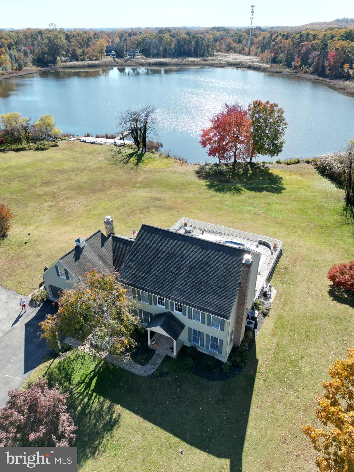 1419 Pond Ridge Drive Pasadena, MD 21122 - Photo 49 of 49 Serene lakeside retreat in vibrant autumn hues.