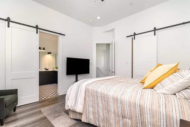 a bedroom with a bed and a television