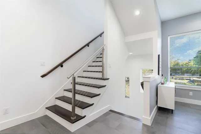 a view of entryway and hall with wooden floor