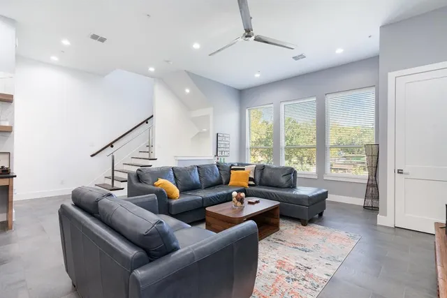 a living room with furniture and wooden floor