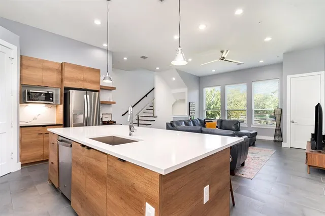 a kitchen with stainless steel appliances kitchen island a large island in the center